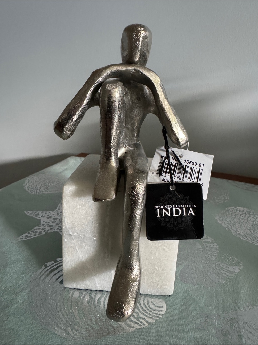 Silver Metal Abstract Sitting Sculpture on White Marble Base